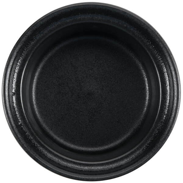 A black Hall China round casserole dish with a rim.