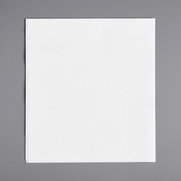 A white square Choice dinner napkin on a gray surface.