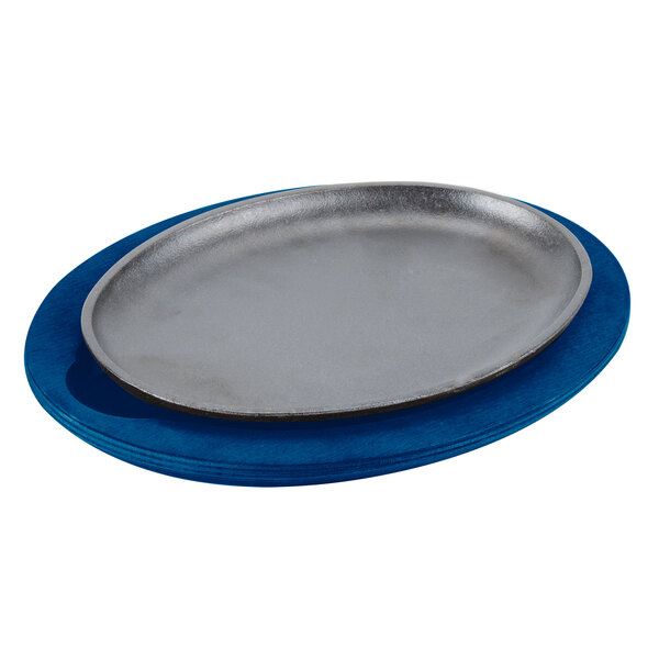 A Lodge cobalt blue wood underliner under a silver plate on a blue plate.