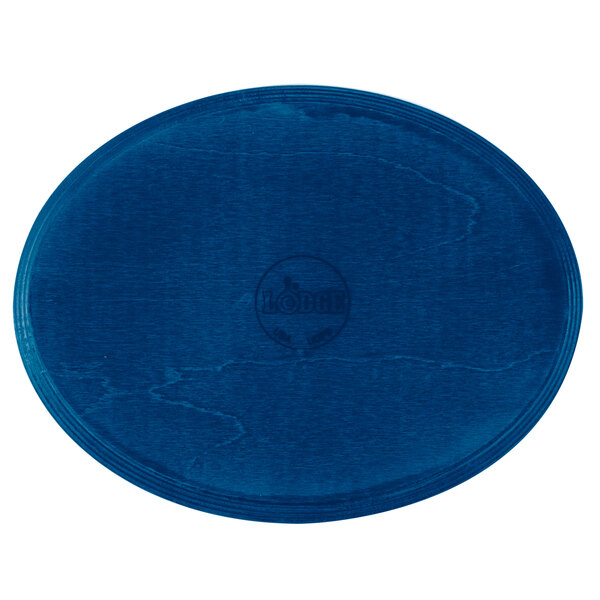 A Lodge cobalt blue oval wood underliner on a table.