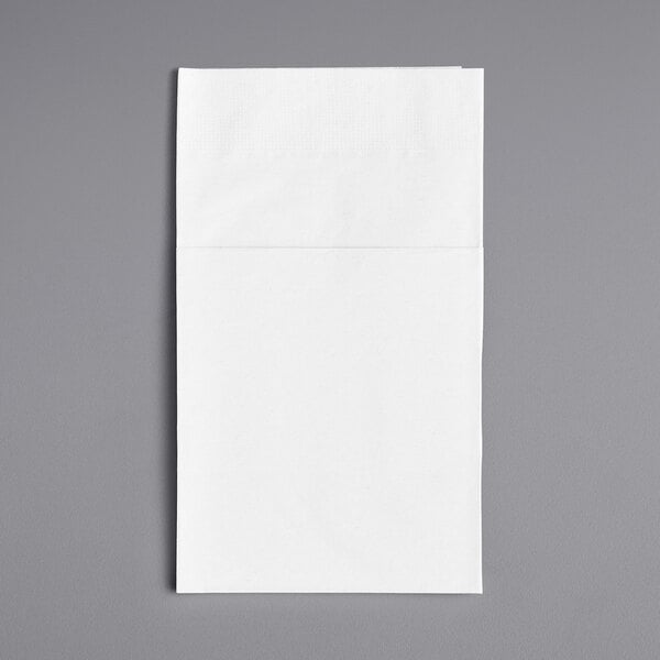 A white napkin with a black frame on a gray surface.