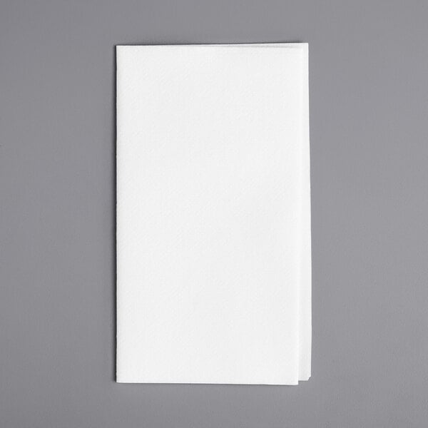 A white linen-feel 1/8 fold dinner napkin on a gray surface.