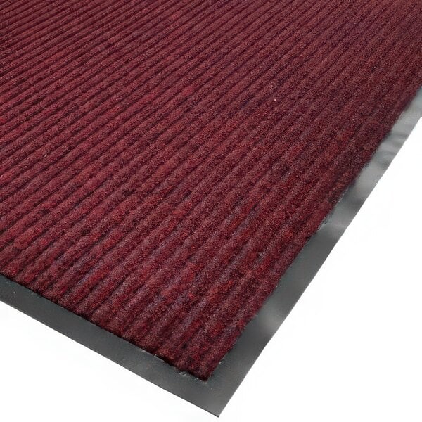 A red needle rib carpet mat roll with black trim.