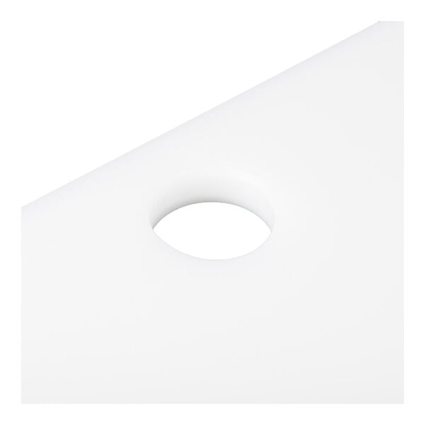 A close-up view of a white, flat surface with a circular hole in the center.