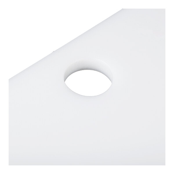A white, flat surface with a circular hole near one corner.
