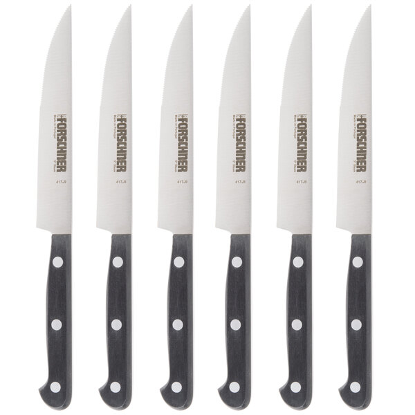 A row of Victorinox steak knives with black handles.