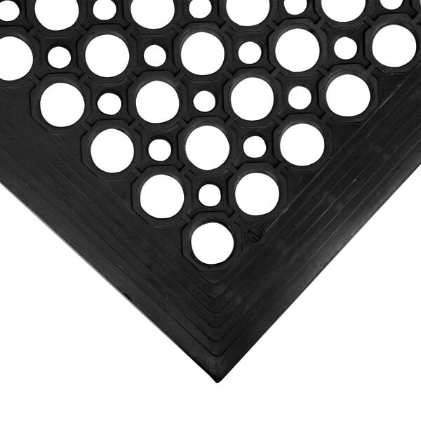 A black rubber Cactus Mat with holes in it.