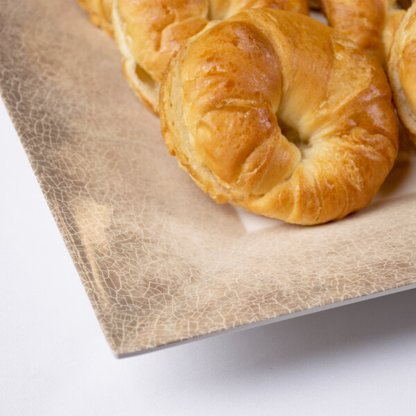 A Thunder Group Jazz melamine plate with croissants on it.
