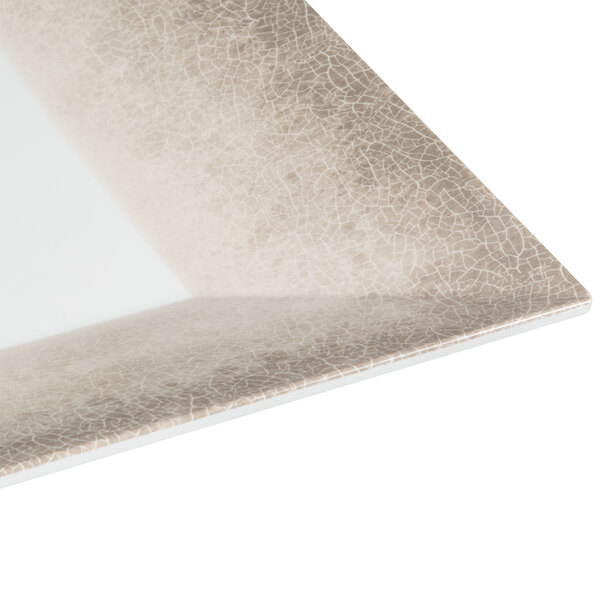 A close up of a Thunder Group Jazz square melamine plate with a white and brown crackle-finished border.