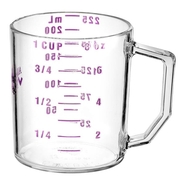 A clear polycarbonate measuring cup with purple measurements on the counter.