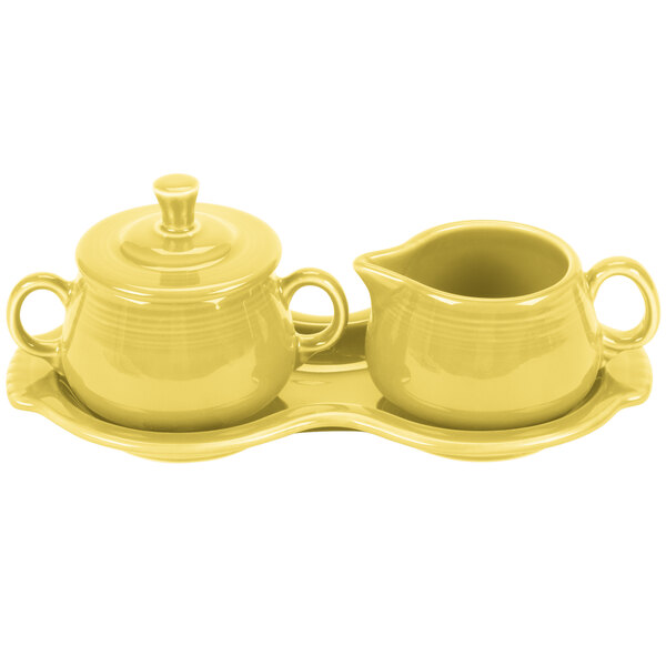 a yellow tea set on a tray