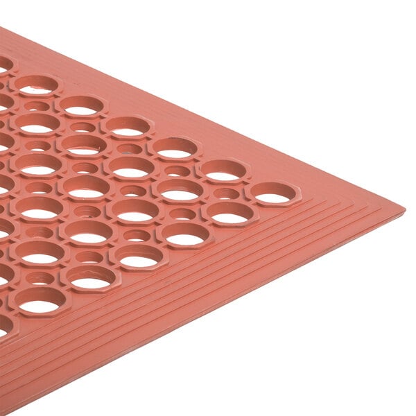 A red Cactus Mat with holes in it.