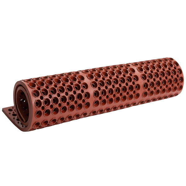 A red Cactus Mat VIP Deluxe rubber floor mat with holes.