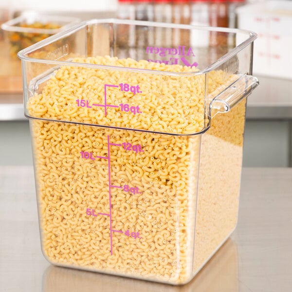 A Cambro CamSquares clear plastic container holding pasta on a counter.