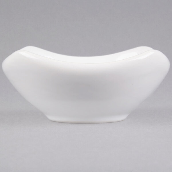 An American Metalcraft white ceramic sauce cup with a curved shape.