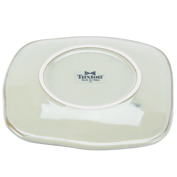 A square white Tuxton Artisan china plate with a white rim.