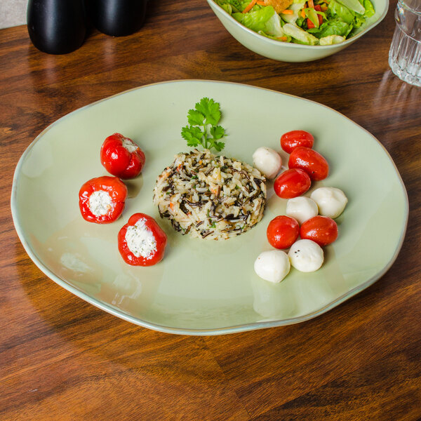 A Tuxton TuxTrendz Artisan Sagebrush China platter with rice and vegetables.