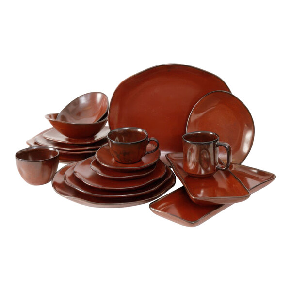 A close up of a red rock bowl with a white background.