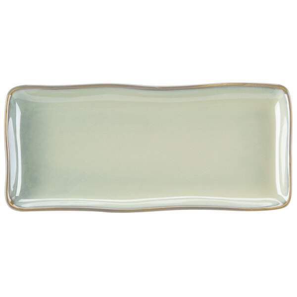 A rectangular white china tray with a light green and gold trim.