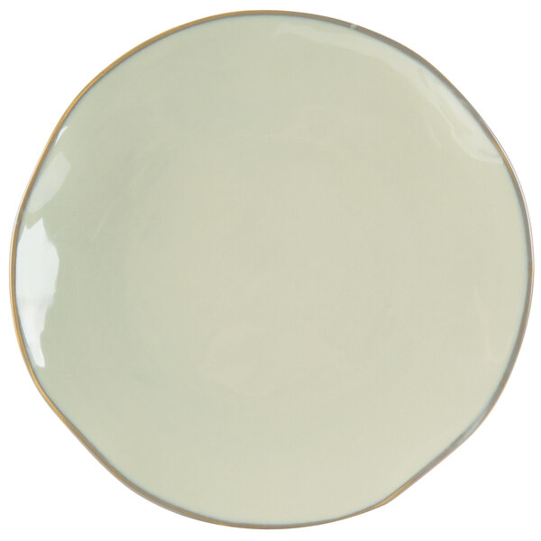 A white Tuxton china plate with a gold rim.