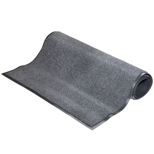 A roll of charcoal carpet with a curved edge on a white background.