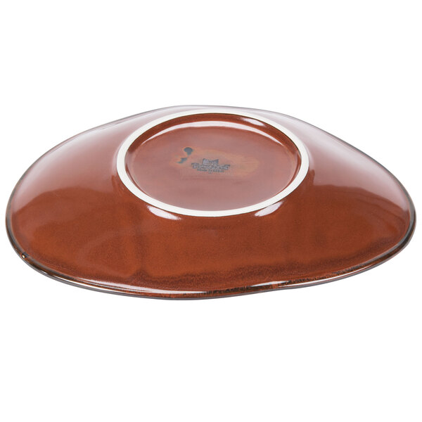 A brown Tuxton china plate with a white rim.