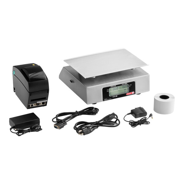 A digital price computing scale with a stainless steel platform, a thermal printer, a roll of printer paper, power adapters, and various connecting cables arranged on a white background.