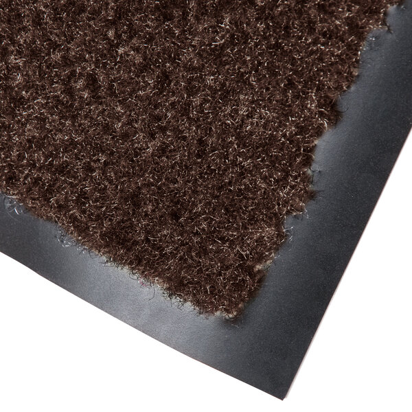 A brown olefin carpet mat with a black backing.