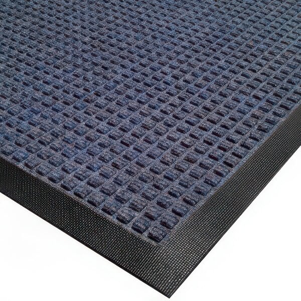 A blue carpet mat with black rubber borders.