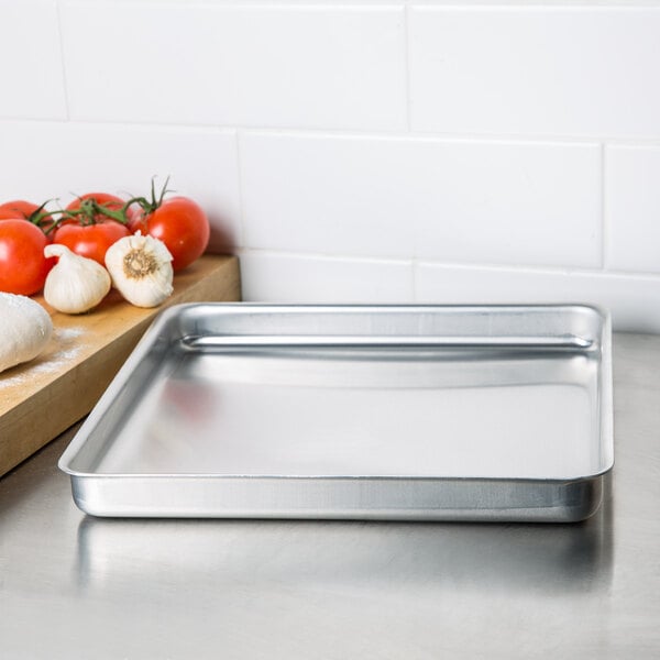 a close-up of a hand holding a metal tray