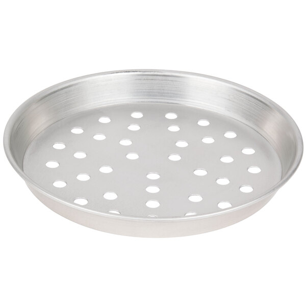 A silver round metal pan with holes.