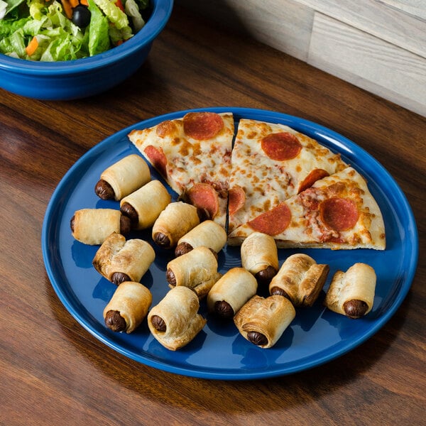 A Fiesta China pizza tray with pizza and rolls on it.