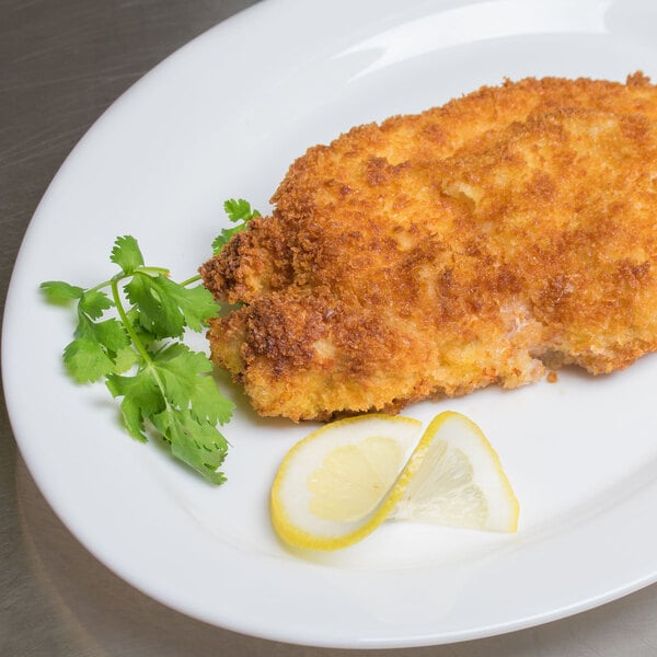 A plate of fried chicken coated in Kikkoman Panko bread crumbs with lemon wedges and parsley.