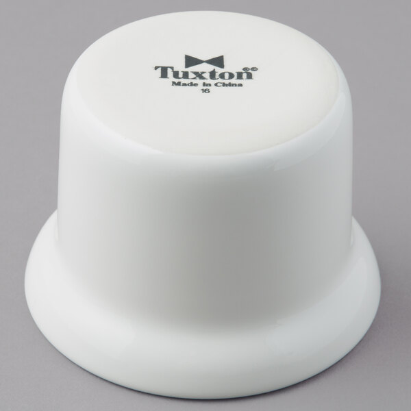 A white Tuxton china bowl with black text.