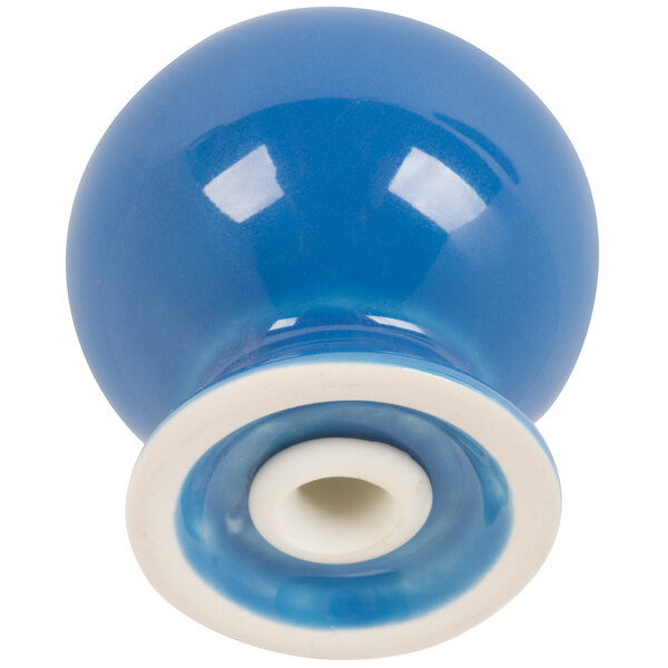 A blue ceramic Fiesta pepper shaker with a white base.