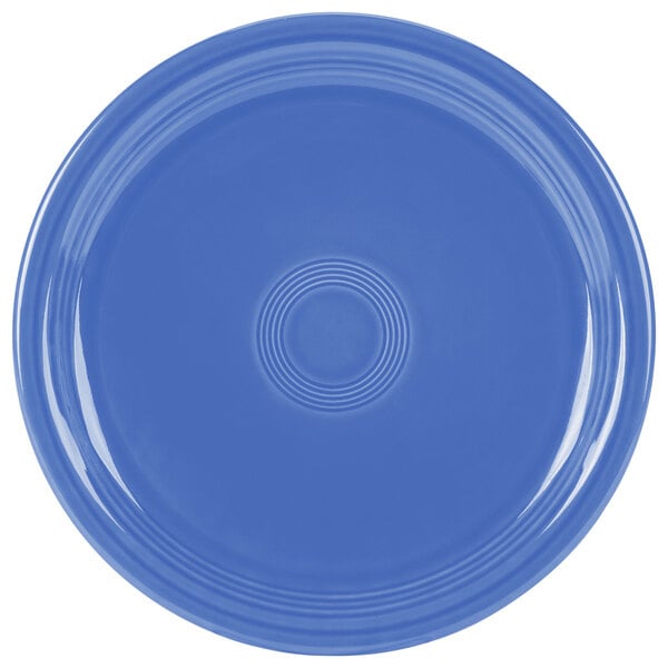 A close-up of a Fiesta® Lapis blue plate with a circular design.