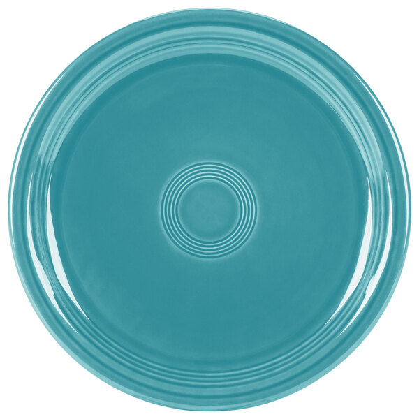 A turquoise plate with a circular pattern.