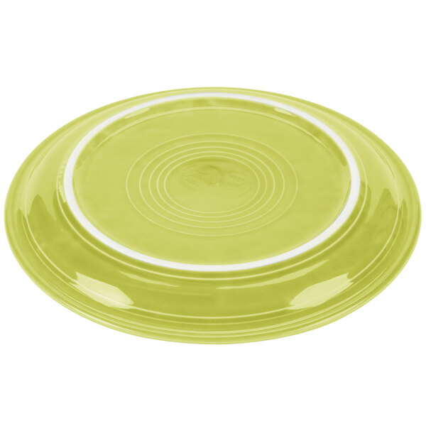 A Lemongrass yellow Fiesta® plate with a white rim.
