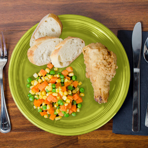 A piece of bread on a green Fiesta healthcare plate.