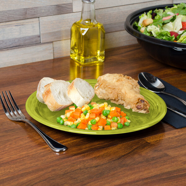 A Fiesta lemongrass plate with food on a table with a fork.