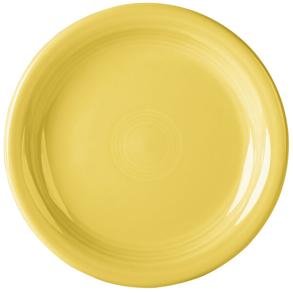 A close-up of a yellow Fiesta appetizer plate with a ring on it.