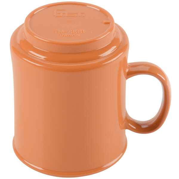 A close-up of a GET Diamond Harvest pumpkin mug with a brown handle.