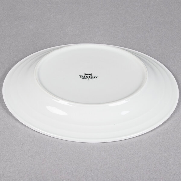A Tuxton bright white china plate with an embossed rim.