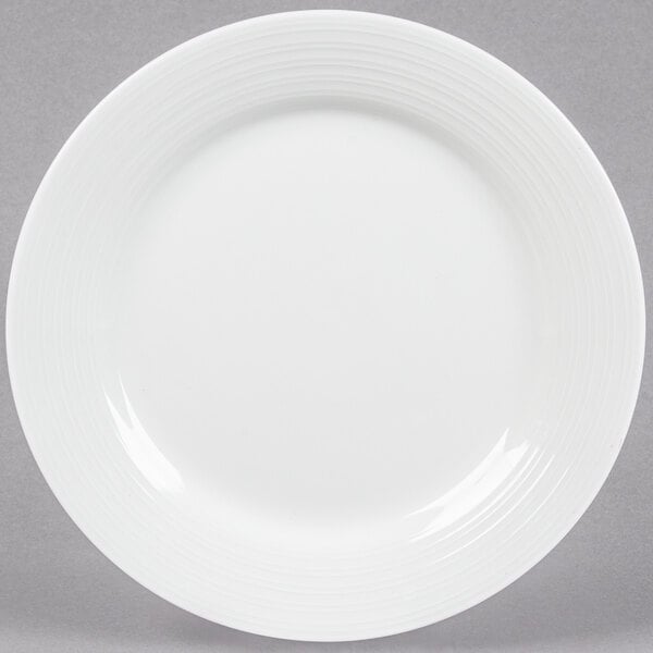 A Tuxton bright white china plate with an embossed swirl design.