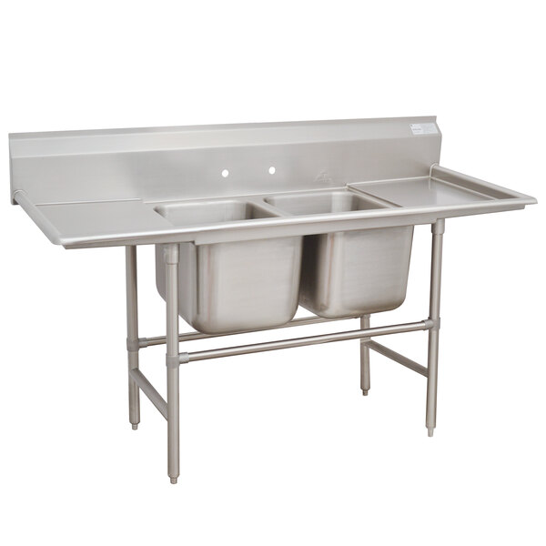 An Advance Tabco stainless steel 2-bowl sink with two drainboards.
