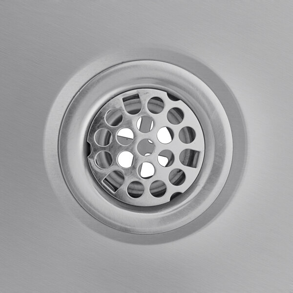 A close-up of a stainless steel right side ice bin drain.