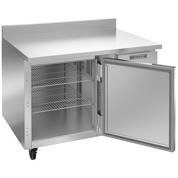 A Beverage-Air stainless steel worktop refrigerator with a door open.