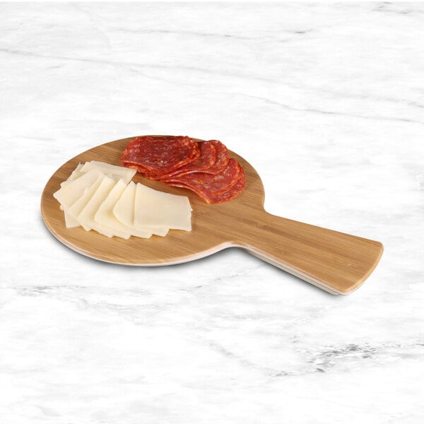 An Elite Global Solutions faux bamboo serving board with slices of meat and cheese on it.