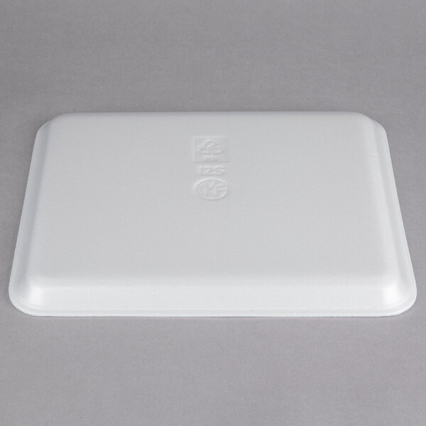 A white styrofoam meat tray with embossed text.