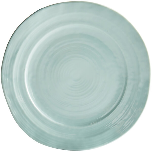 A mint green melamine plate with a circular design.